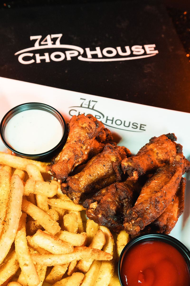 Chicken wings with fries and ranch from 747 Chop House at Capital Cabaret