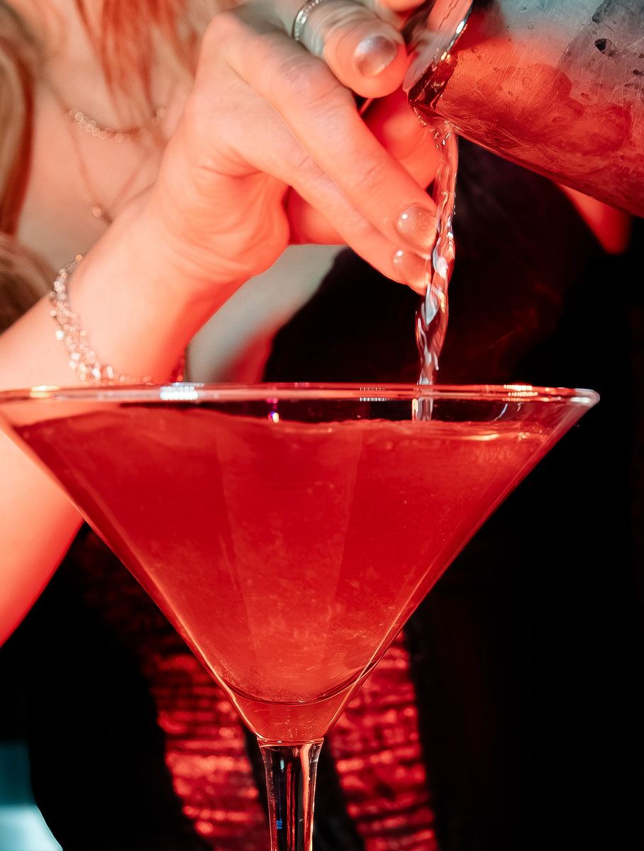 Bartender straining a martini at the Capital Cabaret bar in Raleigh NC