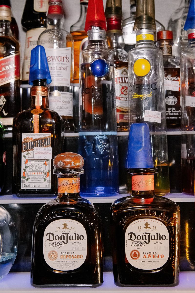 Don Julio reposado and anejo tequila on the back bar at Capital Cabaret